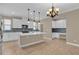Modern kitchen boasts white cabinets, stainless appliances, stylish backsplash, island with pendant lighting at 8348 Vivaro Isle Way, Windermere, FL 34786