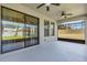Covered lanai with ceiling fans, screen enclosure, and views of the backyard at 8348 Vivaro Isle Way, Windermere, FL 34786
