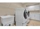 Modern laundry room with a sink, white cabinets, and a side-by-side washer and dryer at 8348 Vivaro Isle Way, Windermere, FL 34786