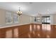 Spacious living room with wood flooring, large windows, and a sliding glass door leading to the backyard at 8348 Vivaro Isle Way, Windermere, FL 34786