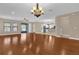 Expansive living room with hardwood floors seamlessly connecting to the kitchen and outdoor area at 8348 Vivaro Isle Way, Windermere, FL 34786