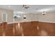 Spacious living room boasts beautiful hardwood floors and neutral paint with a view into the kitchen at 8348 Vivaro Isle Way, Windermere, FL 34786