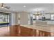 Open concept living room, hardwood flooring, with sliding doors and view of the modern kitchen at 8348 Vivaro Isle Way, Windermere, FL 34786