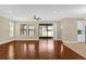 Open-concept living room with hardwood floors and sliding glass doors at 8348 Vivaro Isle Way, Windermere, FL 34786