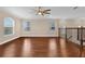 Upstairs loft area features hardwood floors, natural light, and staircase with rod iron railing at 8348 Vivaro Isle Way, Windermere, FL 34786