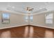 Main bedroom with three large windows and tray ceiling with fan at 8348 Vivaro Isle Way, Windermere, FL 34786