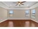 Main bedroom with hardwood floors, ceiling fan, and two windows at 8348 Vivaro Isle Way, Windermere, FL 34786