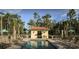 Community pool with ample lounge chairs and surrounding mature landscaping at 8348 Vivaro Isle Way, Windermere, FL 34786