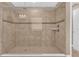 Tiled shower with dual shower heads and a built-in seat at 8348 Vivaro Isle Way, Windermere, FL 34786