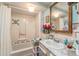 Bathroom showcases a classic tub, sink, vanity, and accents, complete with blue wallpaper and a gold-trimmed mirror at 9000 Us Highway 192 # 115, Clermont, FL 34714