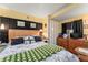 Comfortable bedroom features a large bed, a wooden dresser, and yellow walls, creating a cozy and inviting space at 9000 Us Highway 192 # 115, Clermont, FL 34714