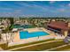 A top-down view of the community pool, tennis courts, clubhouse, and lush landscaping for active lifestyles at 9000 Us Highway 192 # 115, Clermont, FL 34714