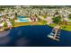 Aerial shot of community pool and marina surrounded by lush greenery and boats docked along the waterfront at 9000 Us Highway 192 # 115, Clermont, FL 34714