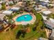 Aerial view of the community pool featuring ample seating, lush landscaping and green spaces for socializing at 9000 Us Highway 192 # 115, Clermont, FL 34714