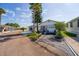 Well-maintained one-story home with landscaped yard and quaint covered porch, inviting and comfortable living spaces at 9000 Us Highway 192 # 115, Clermont, FL 34714