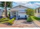 Charming single-story home featuring a well-manicured front yard, vibrant plants, and covered porch seating at 9000 Us Highway 192 # 115, Clermont, FL 34714