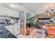 Cozy living room featuring a tiled floor, white kitchen appliances, and decorative backsplash at 9000 Us Highway 192 # 115, Clermont, FL 34714