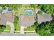 Aerial view of a private residence with a screened pool and lush landscaping at 957 Yellow Rose Dr, Orlando, FL 32818