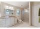 Well-lit bathroom featuring a vanity with marble countertops, a shower, and a closet at 957 Yellow Rose Dr, Orlando, FL 32818