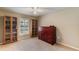Inviting bedroom featuring a window with shutters, built-in bookshelves, and a secretary desk at 957 Yellow Rose Dr, Orlando, FL 32818
