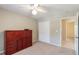 Bedroom with carpeting, closet, and a built-in secretary desk with tiled floor in adjoining room at 957 Yellow Rose Dr, Orlando, FL 32818
