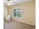 Bright bedroom featuring a chair, carpeted floor, and a window with shutters at 957 Yellow Rose Dr, Orlando, FL 32818
