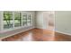 Bedroom featuring hardwood floors, plantation shutters, and lots of natural light at 957 Yellow Rose Dr, Orlando, FL 32818