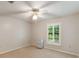 Neutral bedroom featuring large window, neutral walls, and carpeted floor at 957 Yellow Rose Dr, Orlando, FL 32818