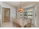 Dining area featuring a chandelier, shuttered windows, and a tile-top table with seating for six at 957 Yellow Rose Dr, Orlando, FL 32818
