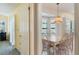 Inviting dining room featuring neutral decor, a vintage chandelier, and bright natural light from shuttered windows at 957 Yellow Rose Dr, Orlando, FL 32818