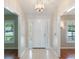 Entryway with tile floors, an ornate light fixture, and sidelight windows at 957 Yellow Rose Dr, Orlando, FL 32818