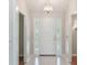 Inviting foyer with tile flooring and an ornate light fixture at 957 Yellow Rose Dr, Orlando, FL 32818