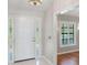 Bright foyer featuring a white front door with sidelights and tile flooring that flows into the home at 957 Yellow Rose Dr, Orlando, FL 32818