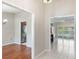 Hallway with views of the kitchen featuring stainless appliances and a pool view through shuttered windows at 957 Yellow Rose Dr, Orlando, FL 32818