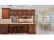 Eat-in kitchen featuring wooden cabinets, stainless steel appliances, and a spacious dining area at 957 Yellow Rose Dr, Orlando, FL 32818