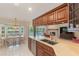 Spacious eat-in kitchen with wooden cabinetry, granite countertops, and views of the pool and fireplace at 957 Yellow Rose Dr, Orlando, FL 32818