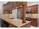 Modern kitchen with rich wood cabinetry, stainless steel appliances, and a breakfast bar, perfect for casual dining at 957 Yellow Rose Dr, Orlando, FL 32818