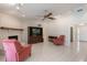 Open living room features tile flooring, fireplace, ceiling fan, and views of the entrance at 957 Yellow Rose Dr, Orlando, FL 32818
