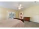 Vaulted ceilings and a large window add to this bright, airy main bedroom with adjoining bath at 957 Yellow Rose Dr, Orlando, FL 32818