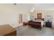 Spacious main bedroom featuring a ceiling fan, two windows with shutters, and an ensuite bathroom at 957 Yellow Rose Dr, Orlando, FL 32818