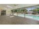 Spacious screened-in patio featuring tile floors and a pool at 957 Yellow Rose Dr, Orlando, FL 32818