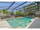 Beautiful pool with screened enclosure and tile border surrounded by lush landscaping at 957 Yellow Rose Dr, Orlando, FL 32818