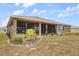 Exterior view of the home showcases a screened patio and landscaped backyard at 9846 Sw 106Th Ct Ocala, F, Ocala, FL 34481