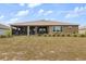 Spacious backyard with a screened-in porch, offering a comfortable outdoor living space for relaxation and entertainment at 9846 Sw 106Th Ct Ocala, F, Ocala, FL 34481