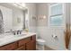 Stylish half bath featuring paneled walls, a dark wood vanity, and a white countertop at 9846 Sw 106Th Ct Ocala, F, Ocala, FL 34481