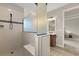 Bathroom with white tiled shower, frameless glass partition, and wood look tile flooring at 9846 Sw 106Th Ct Ocala, F, Ocala, FL 34481