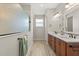 Spacious bathroom featuring double sink vanity with wood cabinets and frameless shower at 9846 Sw 106Th Ct Ocala, F, Ocala, FL 34481