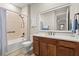 Bright bathroom featuring a tub-shower combo, wood cabinets and quartz countertops at 9846 Sw 106Th Ct Ocala, F, Ocala, FL 34481