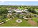 A beautiful view of the clubhouse, tennis courts, and golf course with lush trees at 9846 Sw 106Th Ct Ocala, F, Ocala, FL 34481