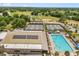 Aerial view of the community pool and tennis courts, baseball field, and solar panels on the roof at 9846 Sw 106Th Ct Ocala, F, Ocala, FL 34481